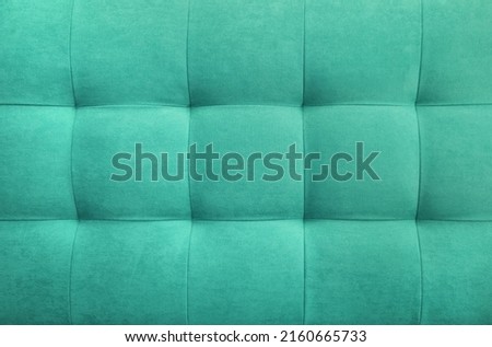 Turquoise suede leather background for the wall in the room. Interior design, headboards made of furniture fabric, furniture upholstery. Classic checkered pattern for furniture, wall, headboard Royalty-Free Stock Photo #2160665733