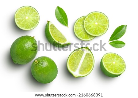 Lime fruits with green leaf and cut in half slice isolated on white background. Top view. Flat lay. Royalty-Free Stock Photo #2160668391