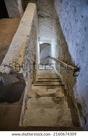 narrow white stone stairs in a castle
