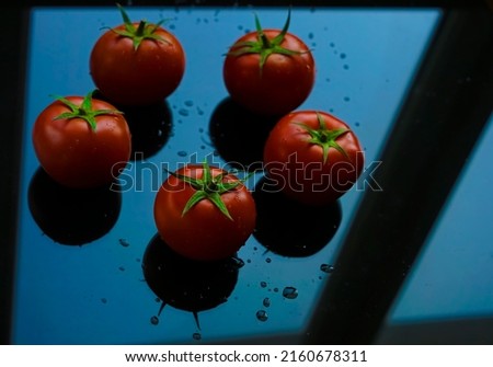 Pile of red tomatoes  isolated on black background. 