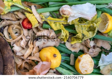 natural fertilizers, Composting pile of rotting kitchen leftover fruits and vegetable scraps background or surface. Fruit and vegetable peels and residues collected to make Composting fertilizers Royalty-Free Stock Photo #2160706779