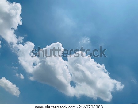 At noon, a large white cumulus cloud. Float in the wind in the beautiful sky at Thailand.no focus