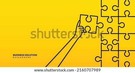 Hand holding jigsaw to completion last puzzle piece on yellow background, Busniess solution  and Completion mission concept