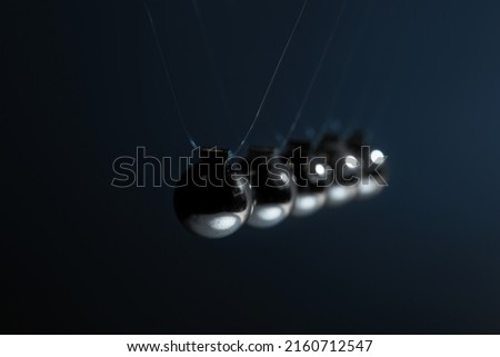 Newton's cradle on black background, closeup. Physics law of energy conservation Royalty-Free Stock Photo #2160712547