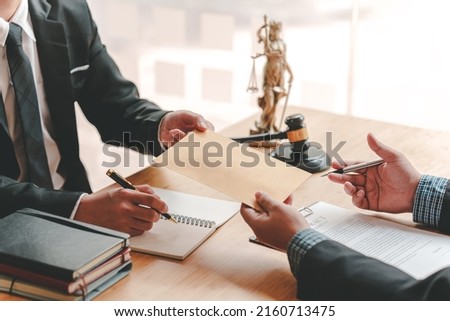 Concepts of corruption, bankruptcy courts, bail, crime, bribery, fraud, Judge Gavel, soundboard, and a handful of cash on the table. Royalty-Free Stock Photo #2160713475