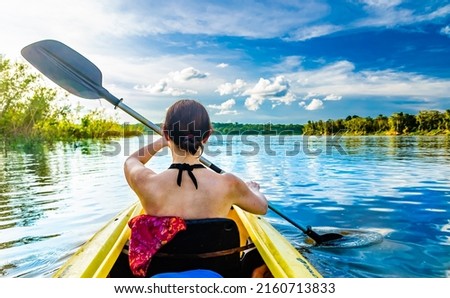 Woman with kayak on the Amazon river, Brazil. High quality photo