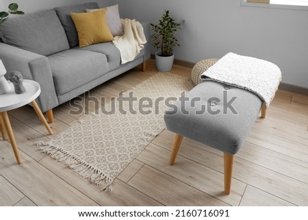 Soft bench with plaid in interior of light living room Royalty-Free Stock Photo #2160716091