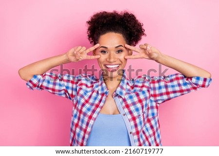 Photo of young cool wavy hairdo lady show v-sign wear plaid shirt isolated on pink color background