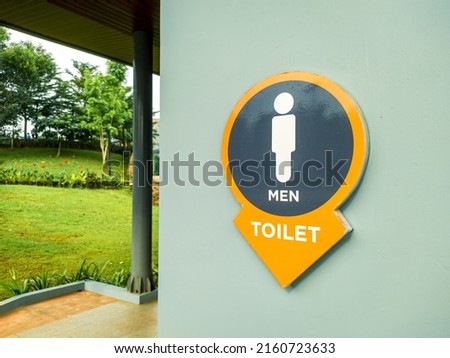 men's restroom signage in a park in the city