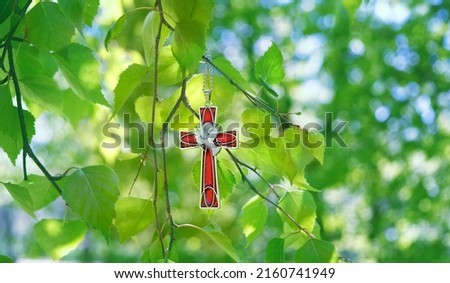 Christian cross with image of a dove on birch branches, abstract green natural background. symbol of Holy Spirit. Holy Trinity Sunday, festive Pentecost day. Faith in God, Church holiday concept Royalty-Free Stock Photo #2160741949