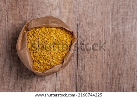 Whole grains of soybeans in paper bags on wooden floor