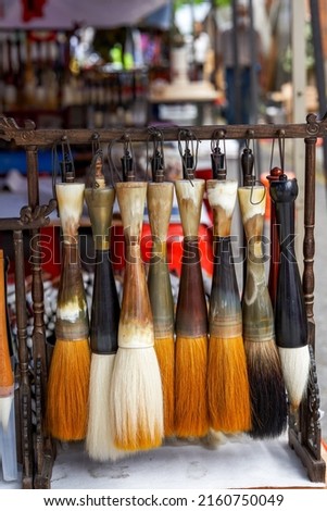 Close-up of various traditional Chinese brushes sold in the market