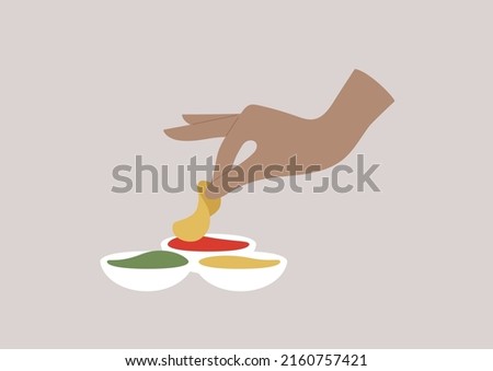A hand dipping a potato chip into a tomato sauce Royalty-Free Stock Photo #2160757421