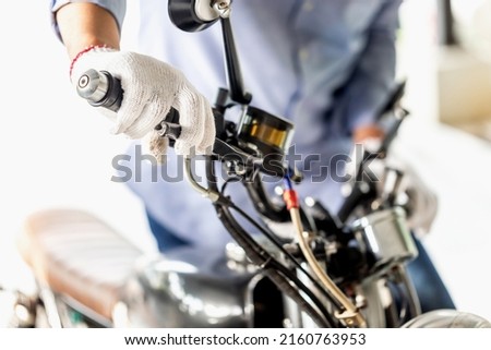 Repairing and maintenance concepts, Man repairing motorcycle in repair shop, Mechanic fixing and checking brake system motorbike in workshop garage