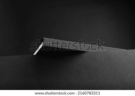 Black branding notebook, brochure mockup template, real photo. Blank isolated on a black background to place your design