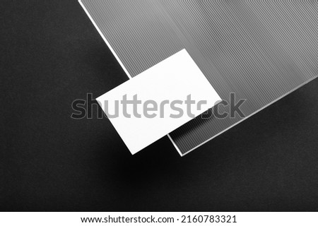 Black branding business card mockup template, with trendy reeded glass elements, real photo. Blank isolated on a black background to place your design
