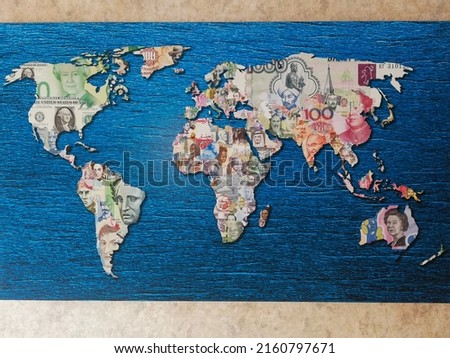 World map with continents made from money of different countries on blue background Royalty-Free Stock Photo #2160797671