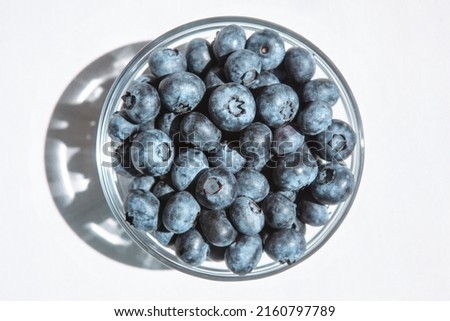 Blue blueberries in glass bowl from the top view, healthy food