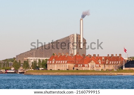 Amager Bakke, Slope or Copenhill, incineration plant, heat and power waste-to-energy plant and recreational facility in the district of Amager, Copenhagen, Denmark, with old Nyholm Central Guardhouse Royalty-Free Stock Photo #2160799915