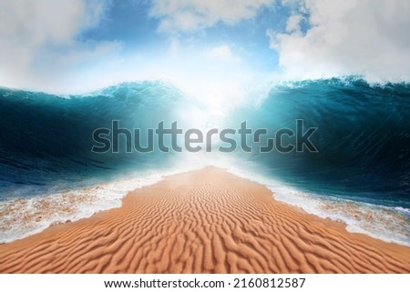 Sea opening up creating a land passage. Parting of the red sea conceptual theme. Royalty-Free Stock Photo #2160812587