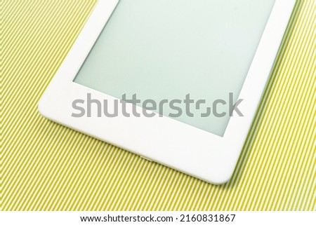 Ebook reader over green striped background