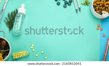 Assortment of herbal and traditional medicine on colourful background. Traditional healthcare concept. Natural homoeopathic remedies. Top view, flat lay, copy space
