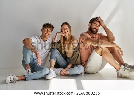 Photo of couple friends sitting and smiling  