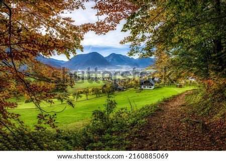 A village in a mountain valley in autumn. Mountain valley village in autumn. Autumn mountain valley village. Valley village in autumn mountains Royalty-Free Stock Photo #2160885069
