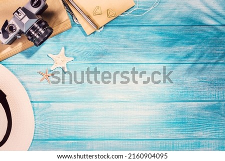 Top view of summer beach accessories on marine blue planks pier. Background with copy space and visible wood texture.