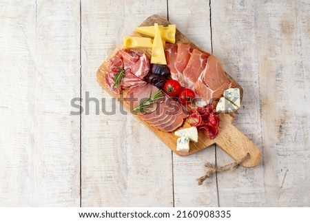 Appetizers table with different antipasti, charcuterie, snacks and cheese. Buffet party. Top view, copy space, negative space Royalty-Free Stock Photo #2160908335