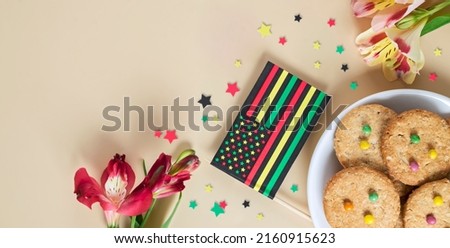 creative banner for Juneteenth day with Black Liberation African American flags, tea cakes cookie and bright flowers