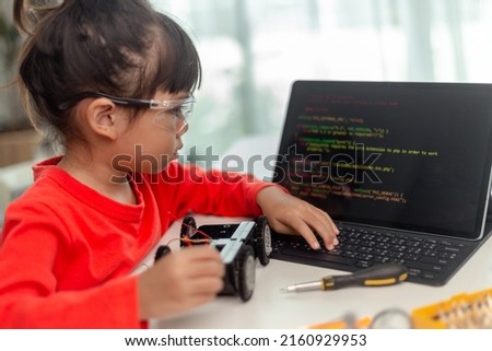 Asia students learn at home in coding robot cars and electronic board cables in STEM, STEAM, mathematics engineering science technology computer code in robotics for kids concept. Royalty-Free Stock Photo #2160929953