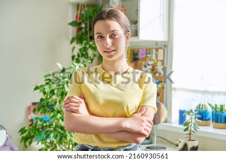 Portrait of smiling teenager girl 14, 15 years old looking at camera, at home in room Royalty-Free Stock Photo #2160930561