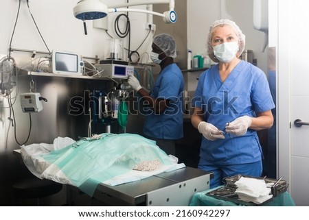 Woman veterinarian and man assistant after operation in a veterinary clinic