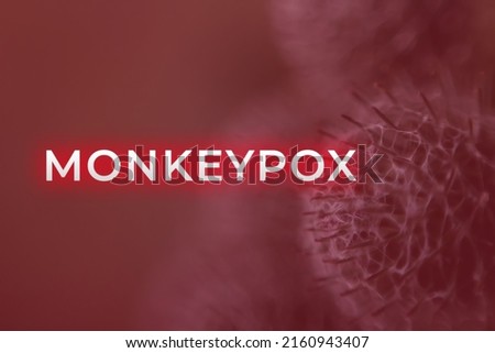 Monkeypox virus. Red background. Outbreak concept. Virus transmitted to humans from animals. Monkeys may harbor the virus and infect people. New pandemic. Word monkeypox. Blurred. Molecular. Virus.