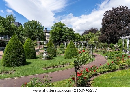 Shrubs trimmed in the form of cones and roses  in Lecoq City Park in Clermont-Ferrand, France. Royalty-Free Stock Photo #2160945299