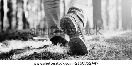 men's footsteps in the woods. black and white toned image