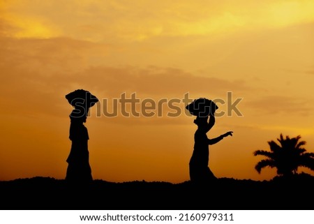 A silhouette of photographer, taking picture of a sunset, man work time