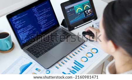 Back rear view of young asian woman, freelance data scientist work remotely at home coding programmer on Big data mining, AI data engineering, IT Technician Works on Artificial Intelligence Project. Royalty-Free Stock Photo #2160981471