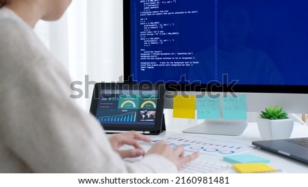 Asia young business woman sit busy at home office desk work code on desktop reskill upskill for job career remote self test IT deep tech ai design skill online html text for cyber security workforce. Royalty-Free Stock Photo #2160981481