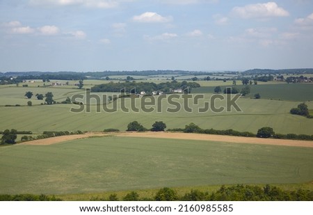 The aerial view of the fields and cousy settlements located in the lowlands surrounding county and university town of Cambridge. Cambridgeshire. United Kingdom