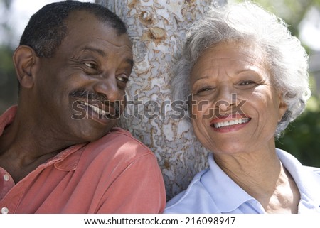 Senior couple outdoors, smiling, close-up