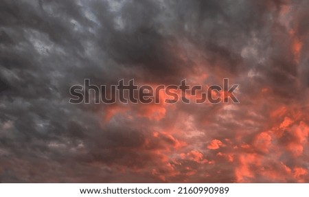 colorful dramatic sky with clouds, steaming cumulonimbus clouds reflect the pink light of the morning sun.	
