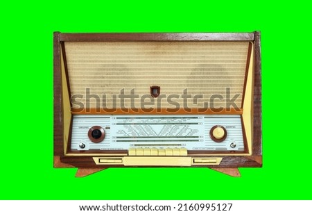 Vintage Radiola (radio) isolated on green background. Latvian Soviet Vintage Radiola (radio) produced from 1965 to 1968.