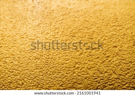 Gold abstract concrete wall background or texture 