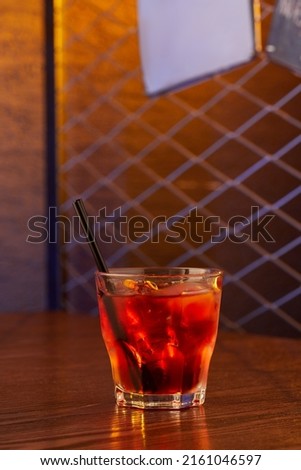 Close-up view of glass with alcohol cocktail on the table in pub. Copy space