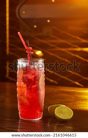 Close-up view of glass with alcohol cocktail on the table in pub. Copy space