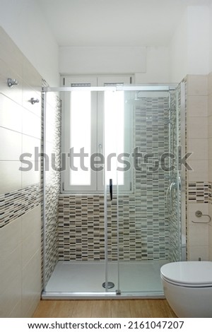 bathroom just renovated with shower cabin, heater and white bathroom fixtures in a new apartment - real estate concept