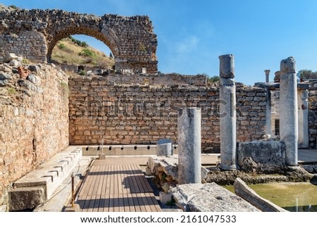 Scenic ruins of the latrines of Ephesus (Efes). Awesome view of public municipal toilets of the ancient Greek city at Izmir Province, Turkey. Ephesus is a popular tourist attraction in Turkey. Royalty-Free Stock Photo #2161047533