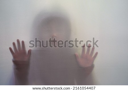 Shadow Small Child behind the curtain.Halloween background. Grunge background With People Abstract Concept. Royalty-Free Stock Photo #2161054407